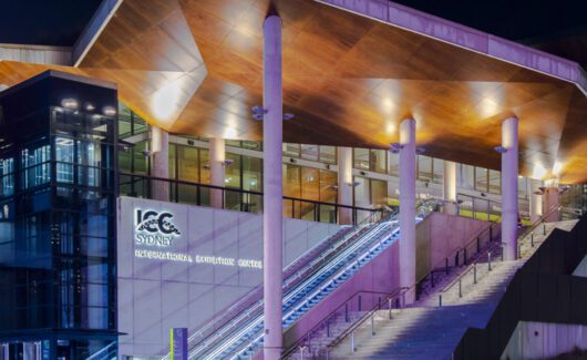 Sydney, Australia, July 23, 2023. Front view of the Sydney ICC (International Convention Centre) illuminated with colourful lights in the evening.