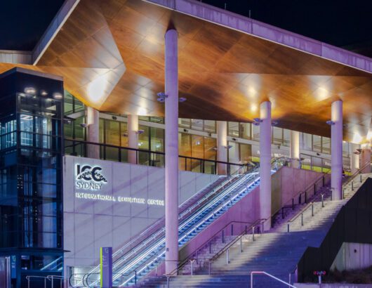Sydney, Australia, July 23, 2023. Front view of the Sydney ICC (International Convention Centre) illuminated with colourful lights in the evening.
